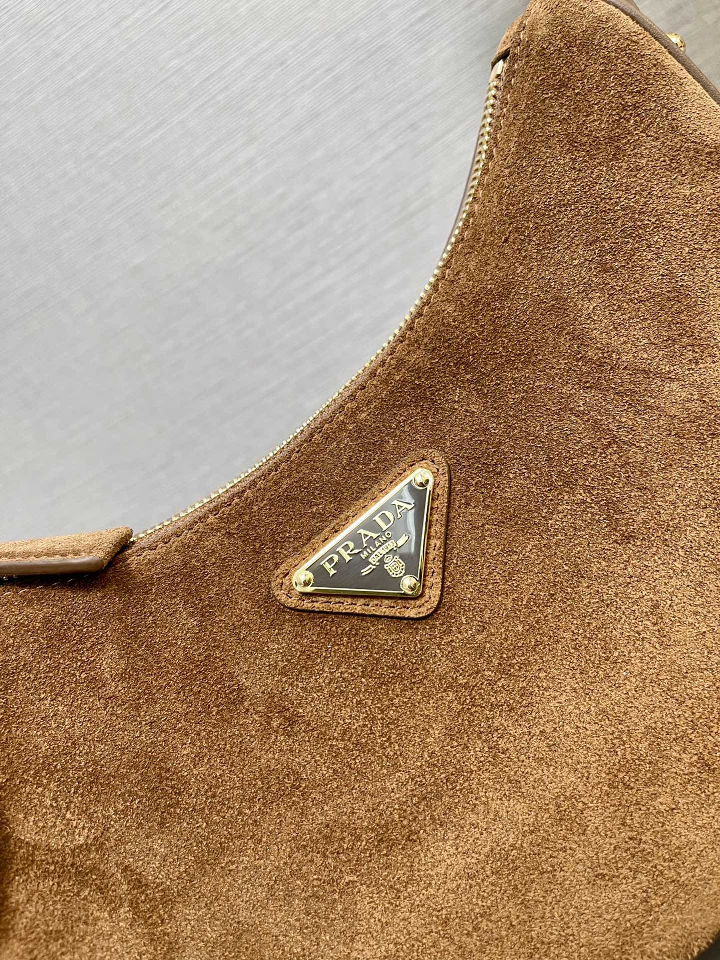 Prada Arqué suede shoulder bag 22.5x18.5x6.5cm